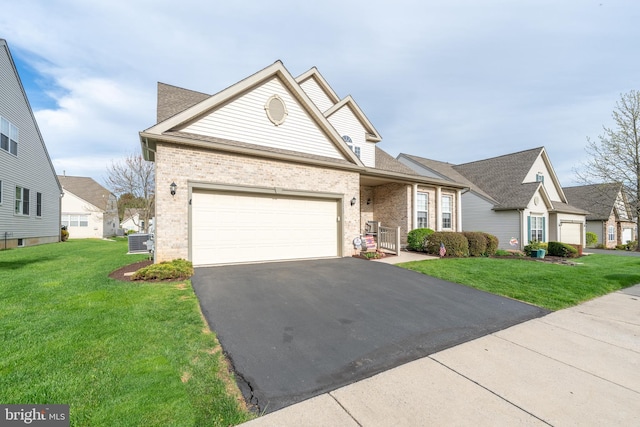 traditional home with brick siding, driveway, and a front lawn
