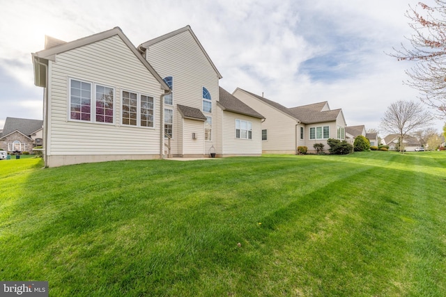 rear view of house with a lawn