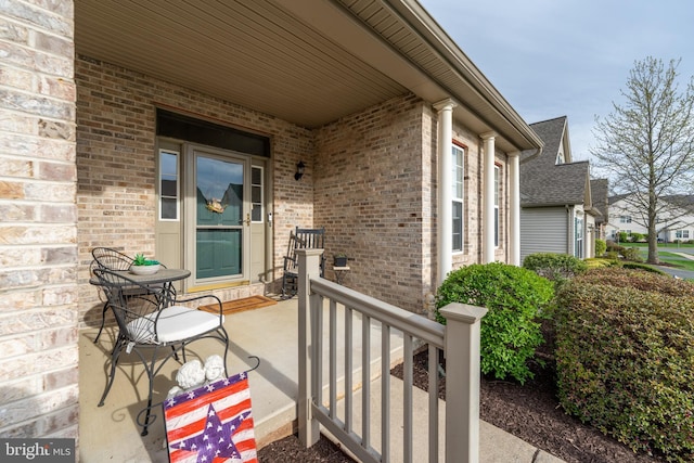 view of exterior entry featuring brick siding