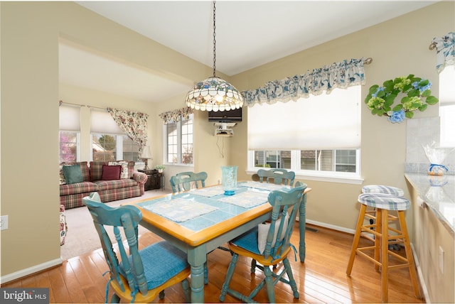 dining room with wood-type flooring and baseboards