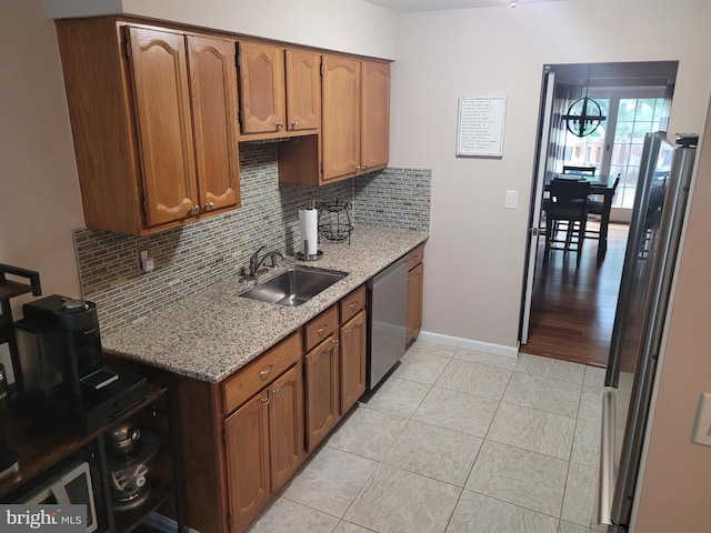 13 Amherst Ct, Bordentown, NJ 08505 - kitchen featuring dishwasher, a sink, decorative backsplash, light stone countertops, and light tile patterned floors