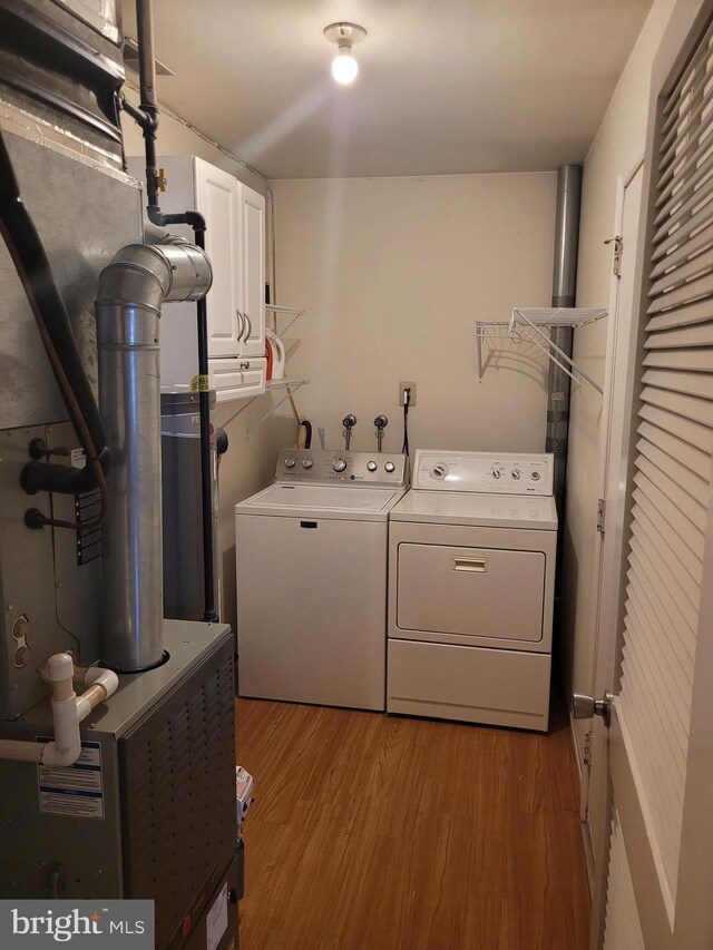 13 Amherst Ct, Bordentown, NJ 08505 - clothes washing area featuring washer and dryer, cabinet space, and wood finished floors