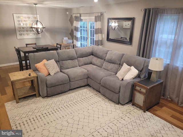 13 Amherst Ct, Bordentown, NJ 08505 - living room featuring a chandelier, light wood-type flooring, and baseboards