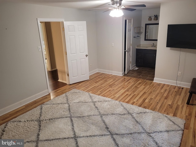 13 Amherst Ct, Bordentown, NJ 08505 - unfurnished bedroom with wood finished floors, a sink, baseboards, and connected bathroom