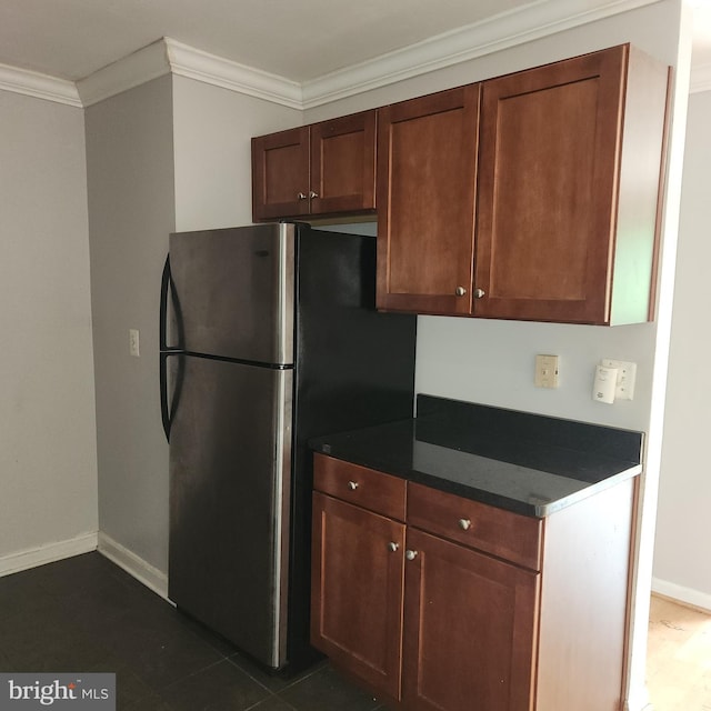 3105 Naylor Rd SE Unit 302, Washington, DC 20020 - kitchen with dark countertops, crown molding, baseboards, and freestanding refrigerator