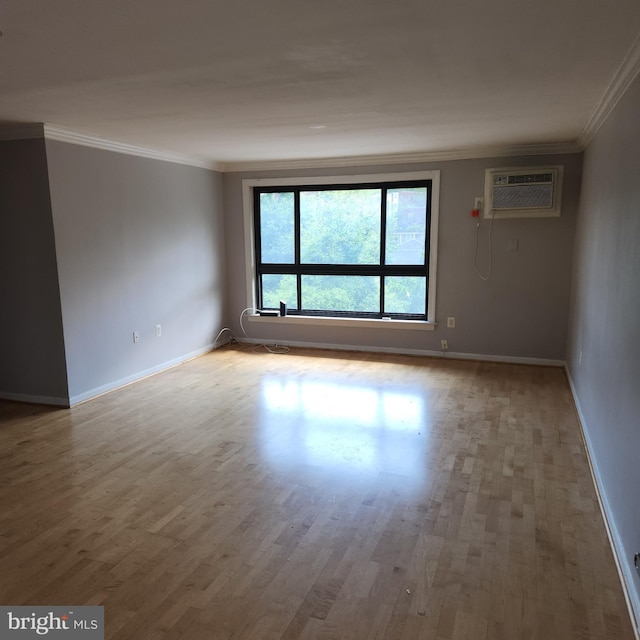 3105 Naylor Rd SE Unit 302, Washington, DC 20020 - empty room featuring a wall mounted AC, ornamental molding, wood finished floors, and baseboards