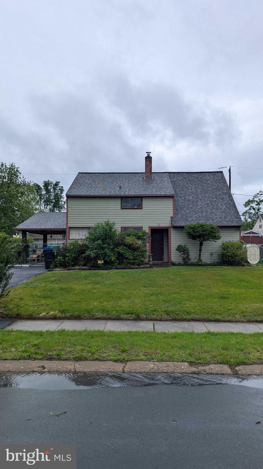 12 Geranium Rd, Levittown, PA 19057 - view of front of house with a front yard and a chimney