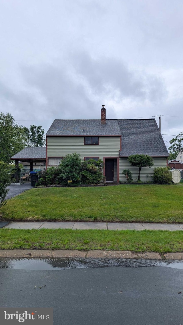 12 Geranium Rd, Levittown, PA 19057 - view of front of house with a front yard and a chimney