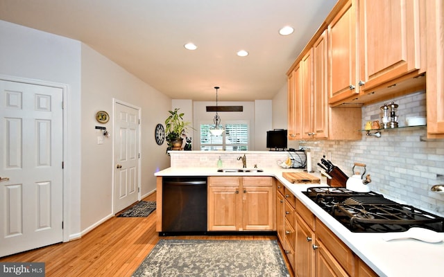 15 Eagle Rd, Phoenixville, PA 19460 - kitchen with black appliances, a sink, a peninsula, light wood-style floors, and tasteful backsplash