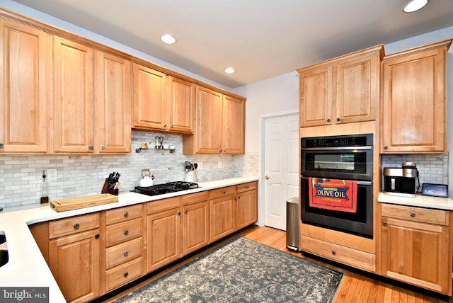 15 Eagle Rd, Phoenixville, PA 19460 - kitchen with black appliances, light wood-type flooring, decorative backsplash, recessed lighting, and light countertops