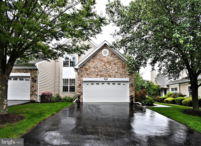 15 Eagle Rd, Phoenixville, PA 19460 - view of front of house with stone siding, asphalt driveway, a front yard, and a garage