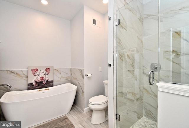15 Eagle Rd, Phoenixville, PA 19460 - full bathroom featuring a soaking tub, a marble finish shower, tile walls, recessed lighting, and toilet