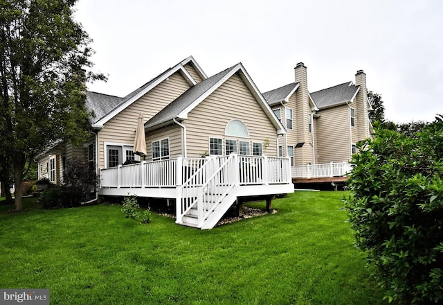 15 Eagle Rd, Phoenixville, PA 19460 - rear view of property featuring a wooden deck, a lawn, and roof with shingles