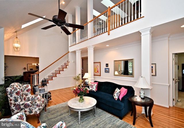 15 Eagle Rd, Phoenixville, PA 19460 - living room featuring wood finished floors, stairway, a towering ceiling, a ceiling fan, and ornamental molding
