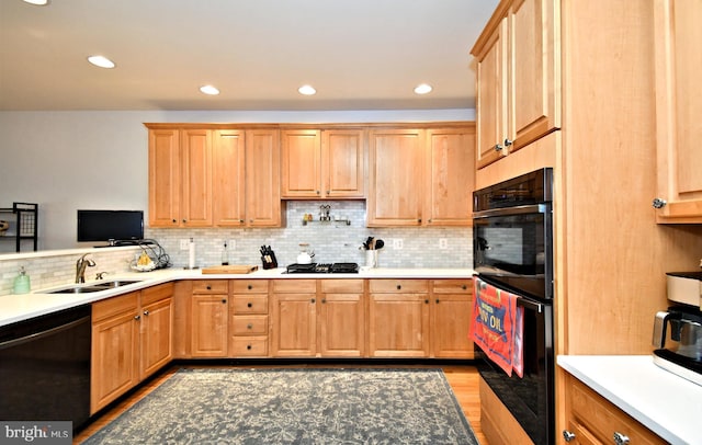 15 Eagle Rd, Phoenixville, PA 19460 - kitchen with black appliances, a sink, decorative backsplash, light wood-type flooring, and light brown cabinets