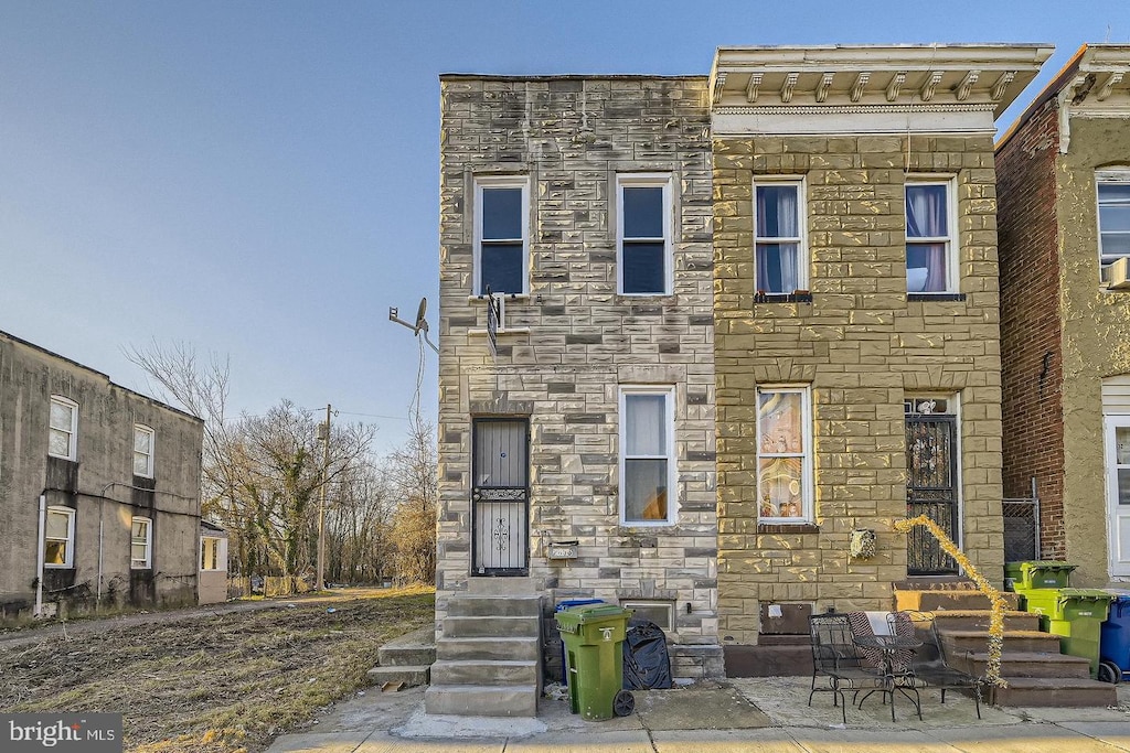 view of property featuring stone siding
