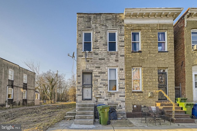 view of property featuring stone siding