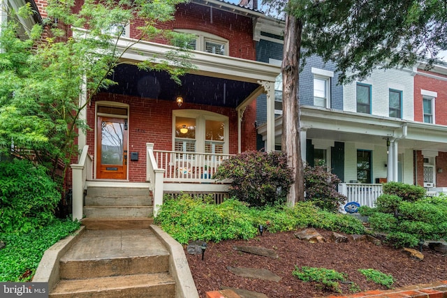 view of front of property with covered porch and brick siding