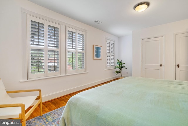 bedroom with wood finished floors and baseboards