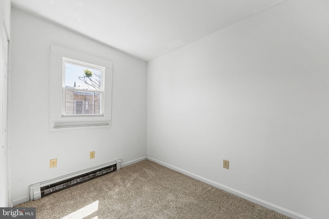 carpeted spare room featuring a baseboard radiator and baseboards