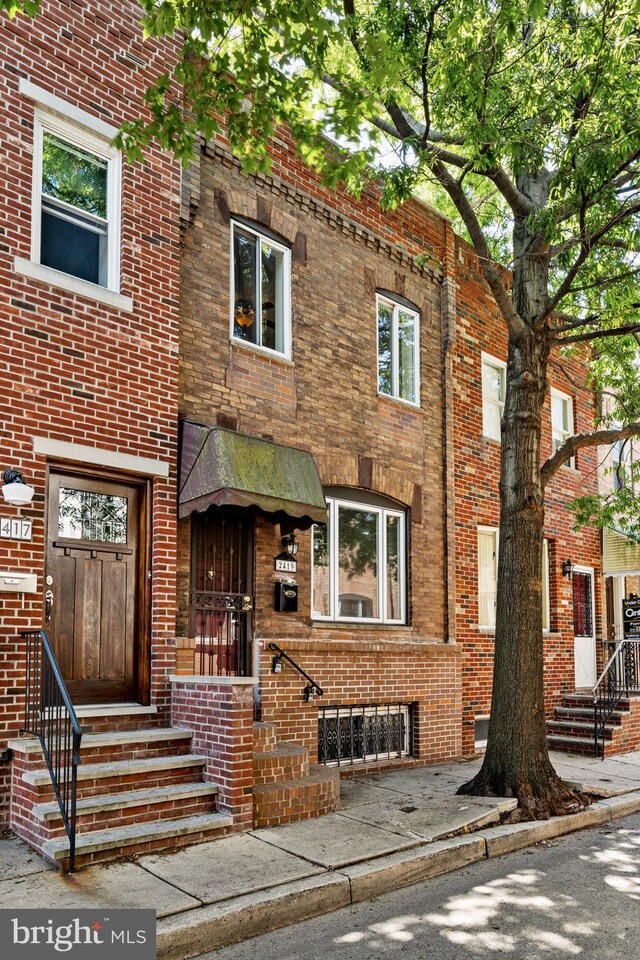 view of front of property with brick siding and entry steps