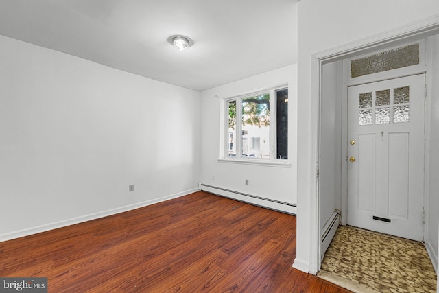 entryway featuring baseboard heating, wood finished floors, and baseboards