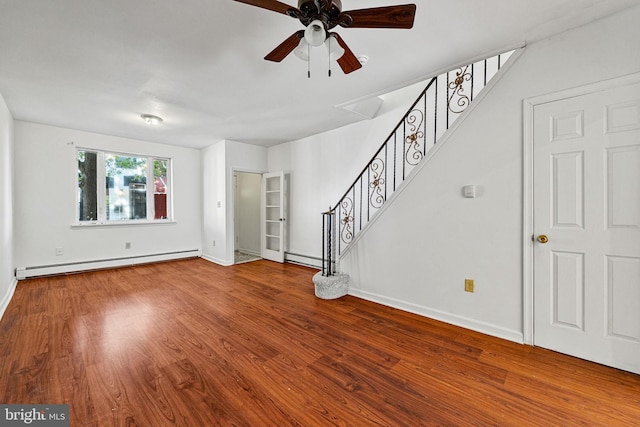 unfurnished living room featuring a baseboard heating unit, stairs, ceiling fan, and wood finished floors