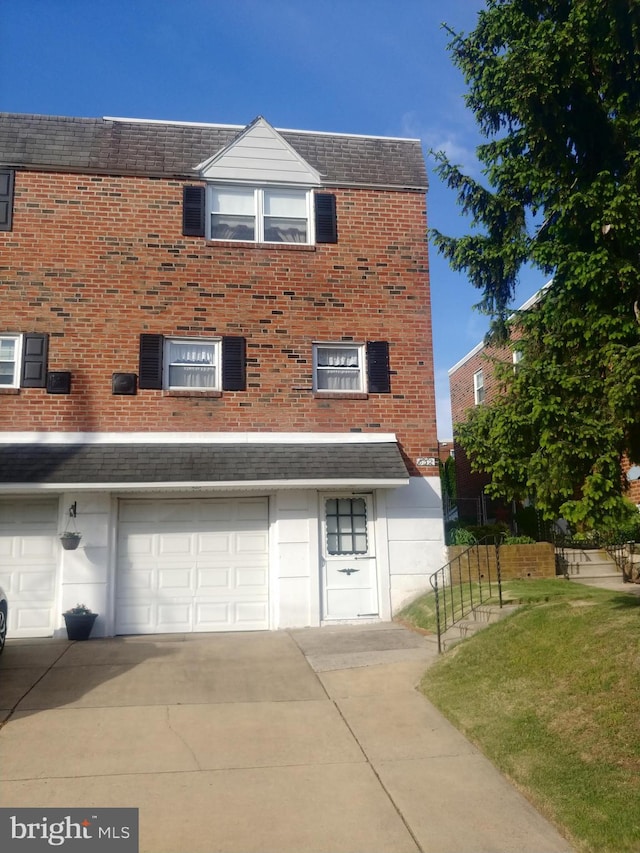 832 Arnold St, Philadelphia, PA 19111 - view of front facade with driveway, a garage, brick siding, and a front yard