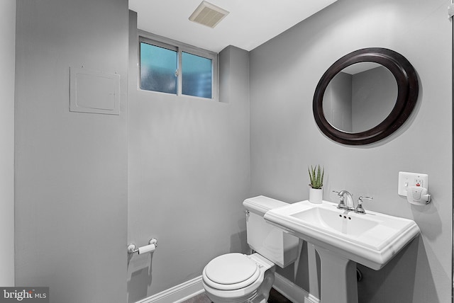 3608 Whispering Ln, Falls Church, VA 22041 - bathroom featuring toilet, baseboards, and a sink