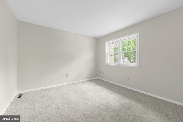 unfurnished room with carpet and baseboards