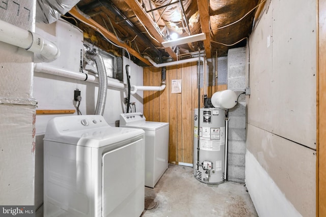 laundry area with gas water heater and washing machine and dryer