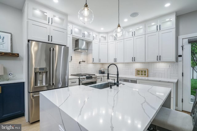 603 N Alfred St, Alexandria, VA 22314 - kitchen with high end appliances, a sink, wall chimney range hood, backsplash, and white cabinetry