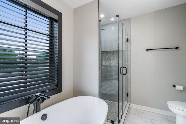 603 N Alfred St, Alexandria, VA 22314 - full bath featuring marble look tiles, baseboards, a freestanding bath, plenty of natural light, and recessed lighting