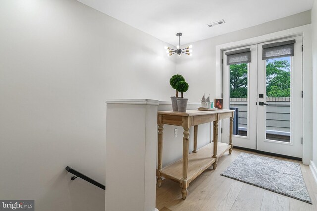 603 N Alfred St, Alexandria, VA 22314 - doorway to outside with wood finished floors, a chandelier, and french doors