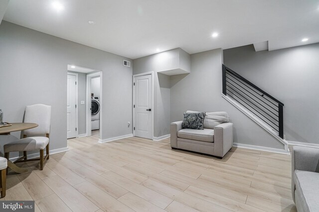 603 N Alfred St, Alexandria, VA 22314 - living area featuring stairway, light wood-type flooring, washer / clothes dryer, baseboards, and recessed lighting