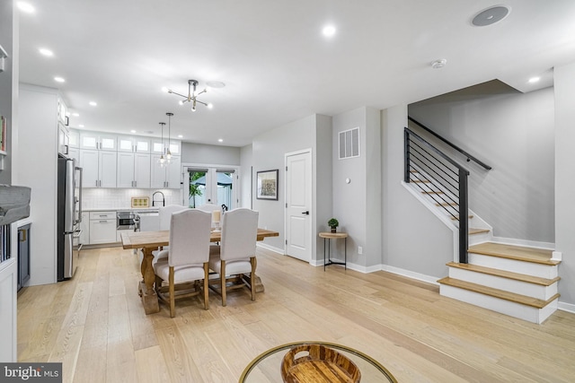 603 N Alfred St, Alexandria, VA 22314 - dining room featuring stairway, light wood finished floors, recessed lighting, and baseboards
