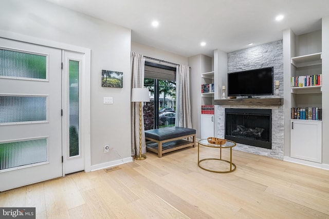 603 N Alfred St, Alexandria, VA 22314 - living room with wood finished floors, a fireplace, baseboards, built in features, and recessed lighting