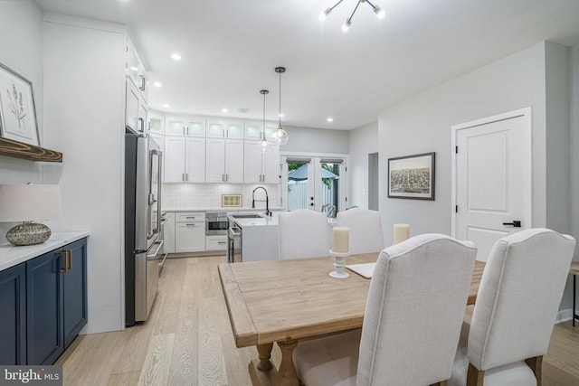 603 N Alfred St, Alexandria, VA 22314 - dining space with light wood-style floors, recessed lighting, and french doors