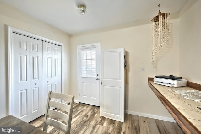 foyer entrance featuring wood finished floors and baseboards
