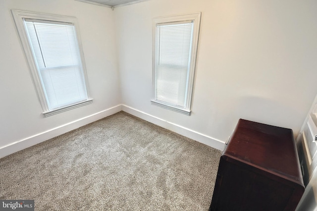 empty room with carpet floors and baseboards