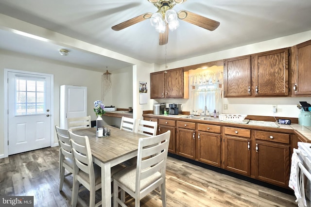 kitchen with a sink, white stove, tile counters, ceiling fan, and plenty of natural light