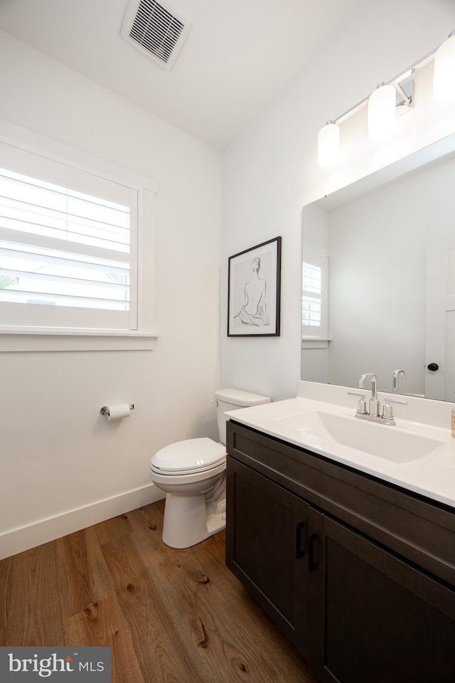 1051 Glen Hall Rd, Kennett Square, PA 19348 - half bath with toilet, vanity, wood finished floors, and baseboards