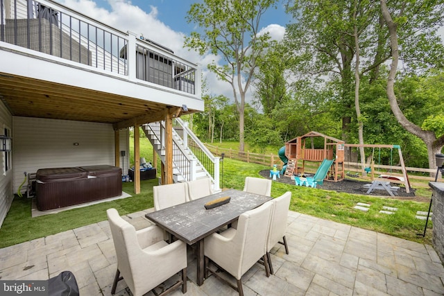 1051 Glen Hall Rd, Kennett Square, PA 19348 - view of patio with a hot tub, a playground, outdoor dining area, stairway, and view of scattered trees