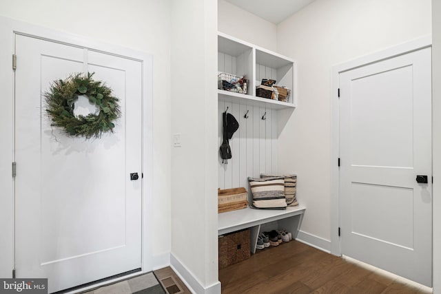 mudroom featuring dark wood finished floors and baseboards