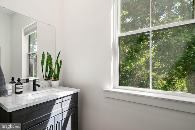 bathroom with healthy amount of natural light and vanity