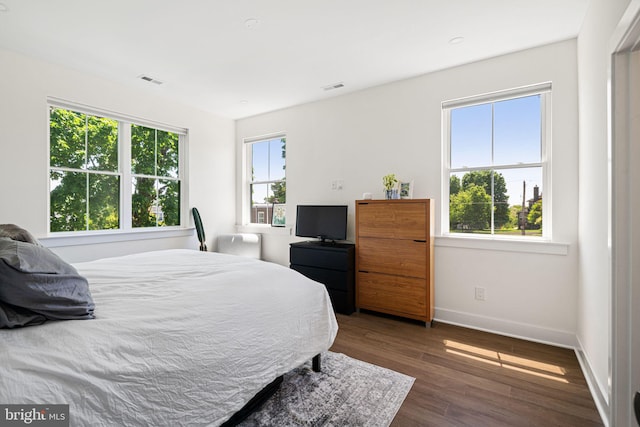 bedroom featuring baseboards and wood finished floors