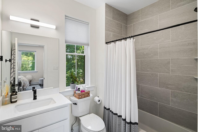 bathroom with vanity, toilet, and shower / bathtub combination with curtain
