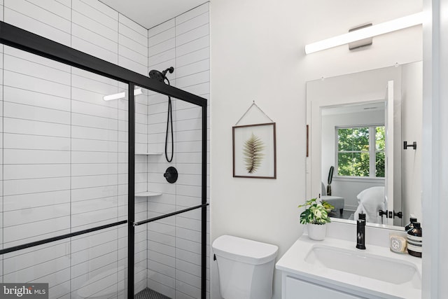 ensuite bathroom with a shower stall, toilet, and vanity