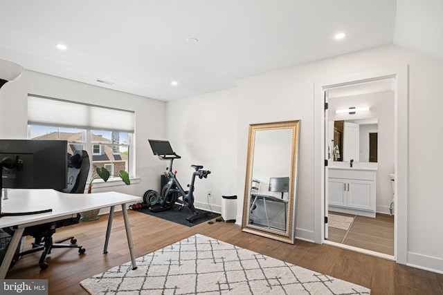 home office featuring wood finished floors, baseboards, and recessed lighting