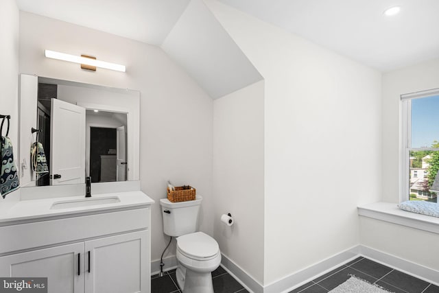 bathroom featuring toilet, vanity, tile patterned flooring, baseboards, and recessed lighting